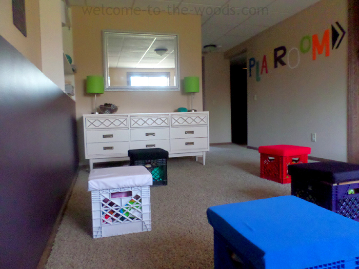 Adorable playroom redo in the basement. Love the wall installation and diy toy storage in milk crates!