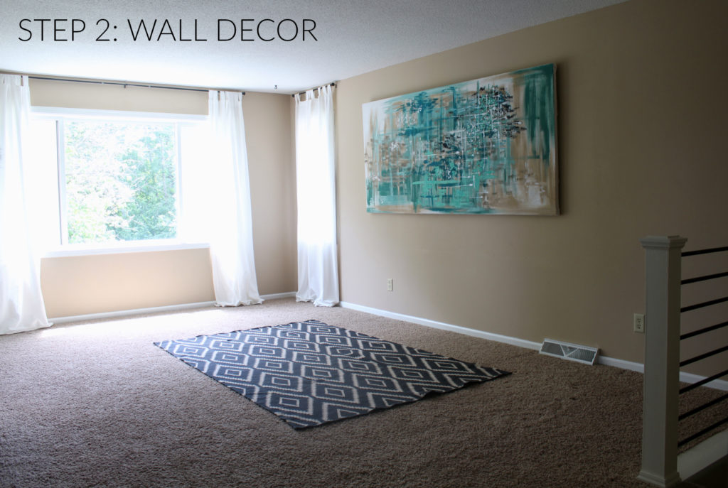 Step 2 in designing a home, is hanging wall art. One large piece of art can really make a statement or cover your large blank wall with a gallery arrangement.
