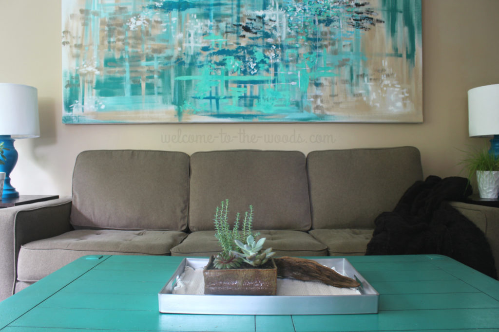 Pops of teal bring this living room design to life. See how the space was put together step by step.
