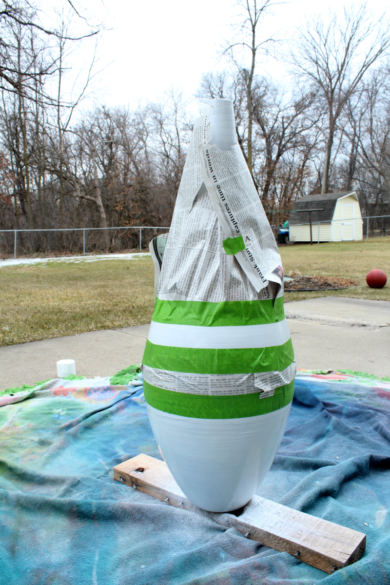 Use frogtape and newspaper to create a design on a vase refresh project.