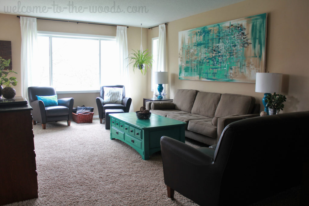Living Room Update with modern furniture, beautiful abstract wall art, and painted teal coffee table. 