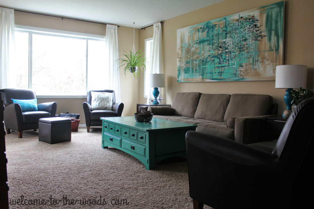 Living room update featuring teal accents, abstract painting, painted furniture, modern aesthetic, diy lamps, and more!
