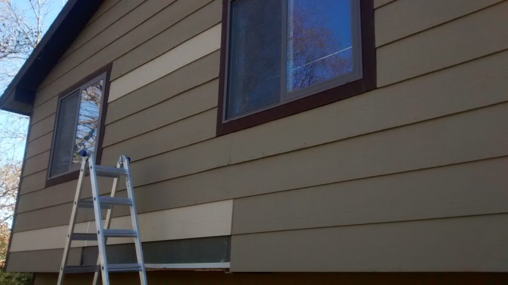 Ripping off old siding to replace rotten pieces