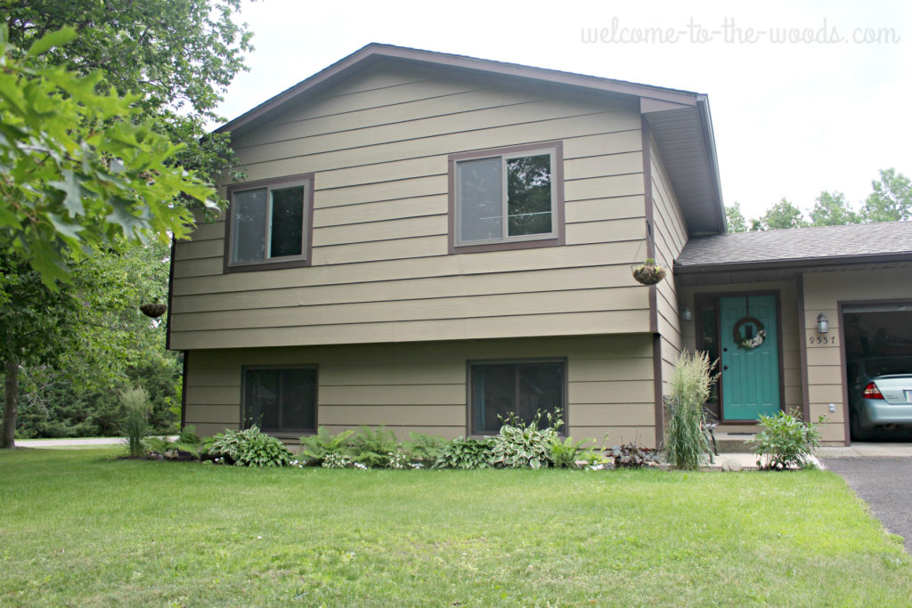 House got a boost of curb appeal with landscaping, tree removal, front door refresh, and siding replacement.