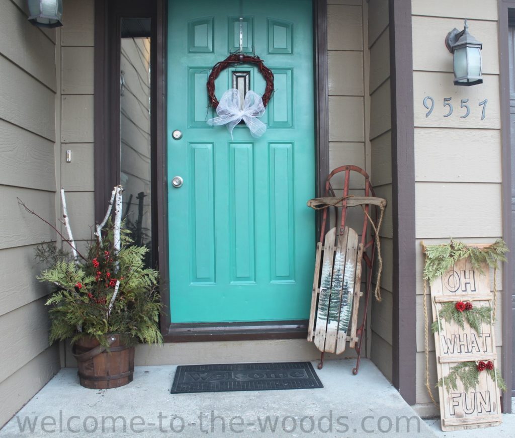 Front entrance holiday decor with painted vintage sled, DIY planter, and homemade wreath!