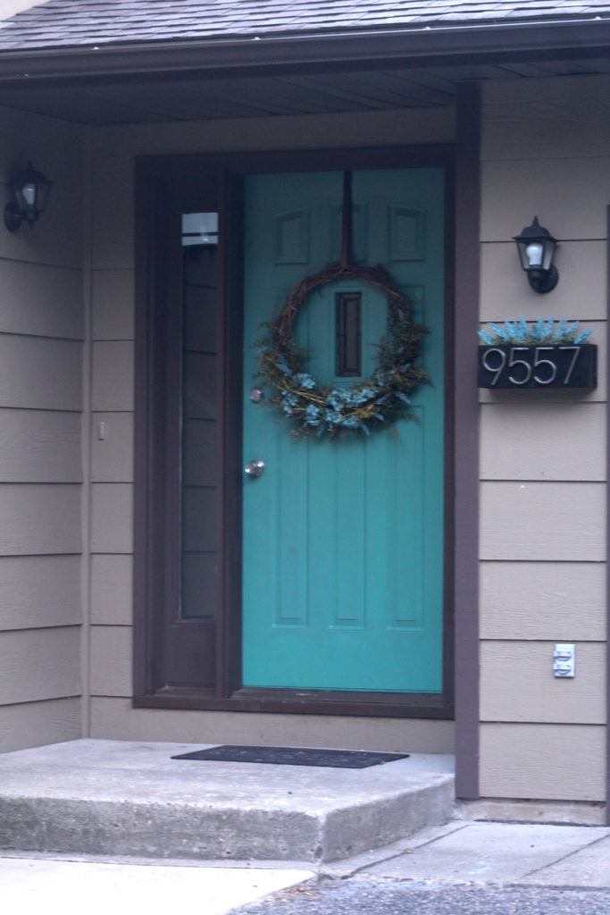 Front Entrance Curb Appeal Bilevel home teal door beige house brown trim black exterior lights