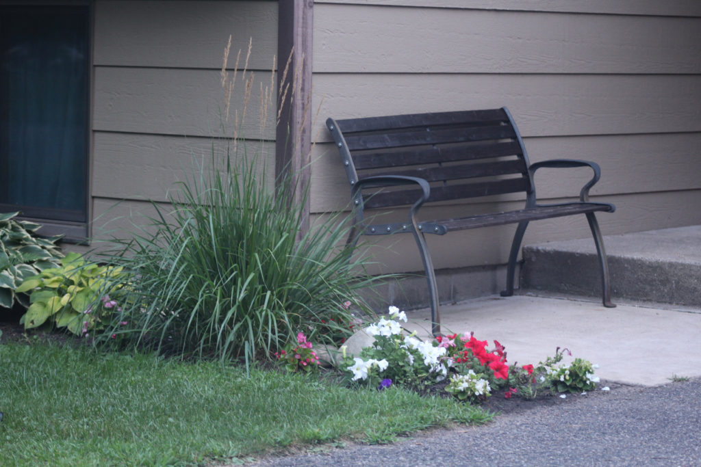 Front entrance curb appeal bench and flowers to welcome guests!