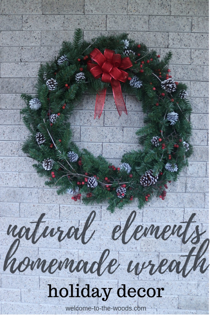 A handmade Christmas wreath made from mostly natural elements in traditional colors of green white and red.