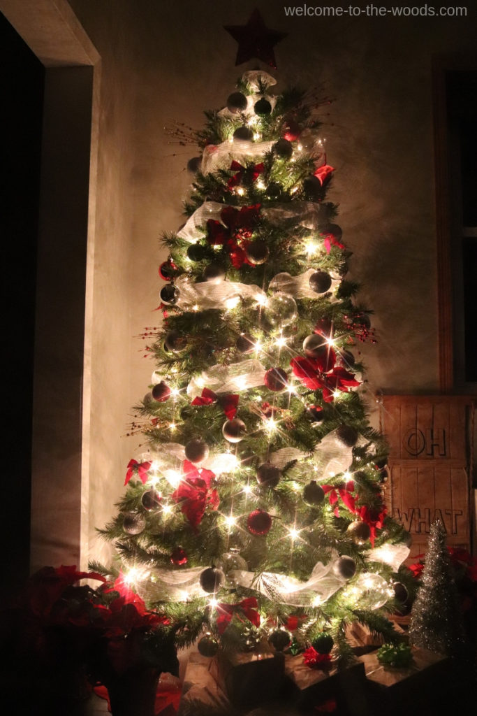 Beautiful Christmas tree lit up at night in the dark holiday decor