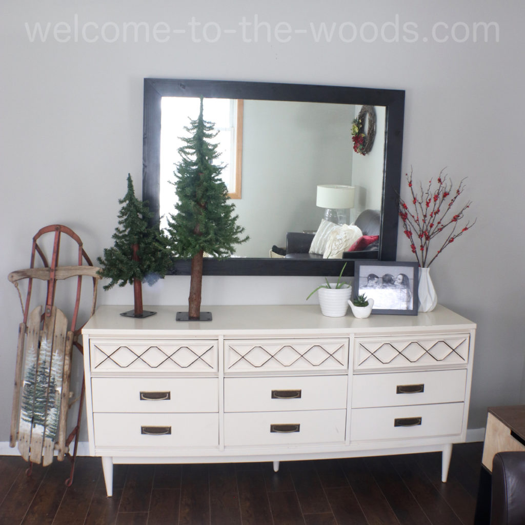Cozy modern living room design vintage sled, mid century painted dresser, black and white accents