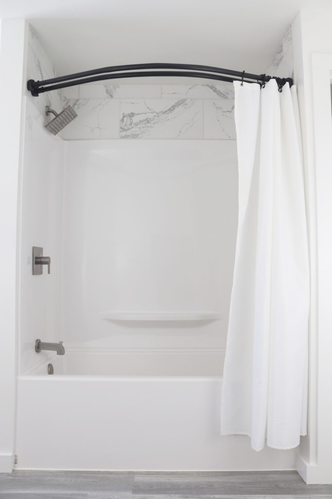Double curved shower curtain rod makes our tub shower surround feel like a luxury hotel