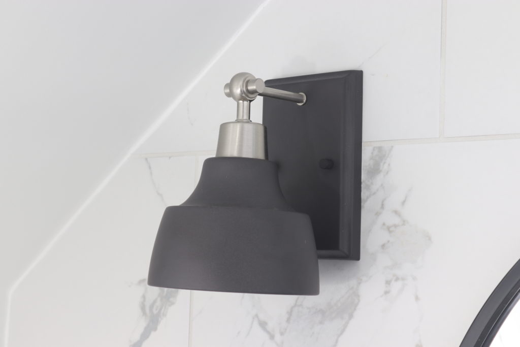 A modern industrial wall sconce perfect for any room of the house! These affordable lights are matte black with brushed nickel, versatile with up or down mounting options, and take a normal light bulb so they're easy to maintain!