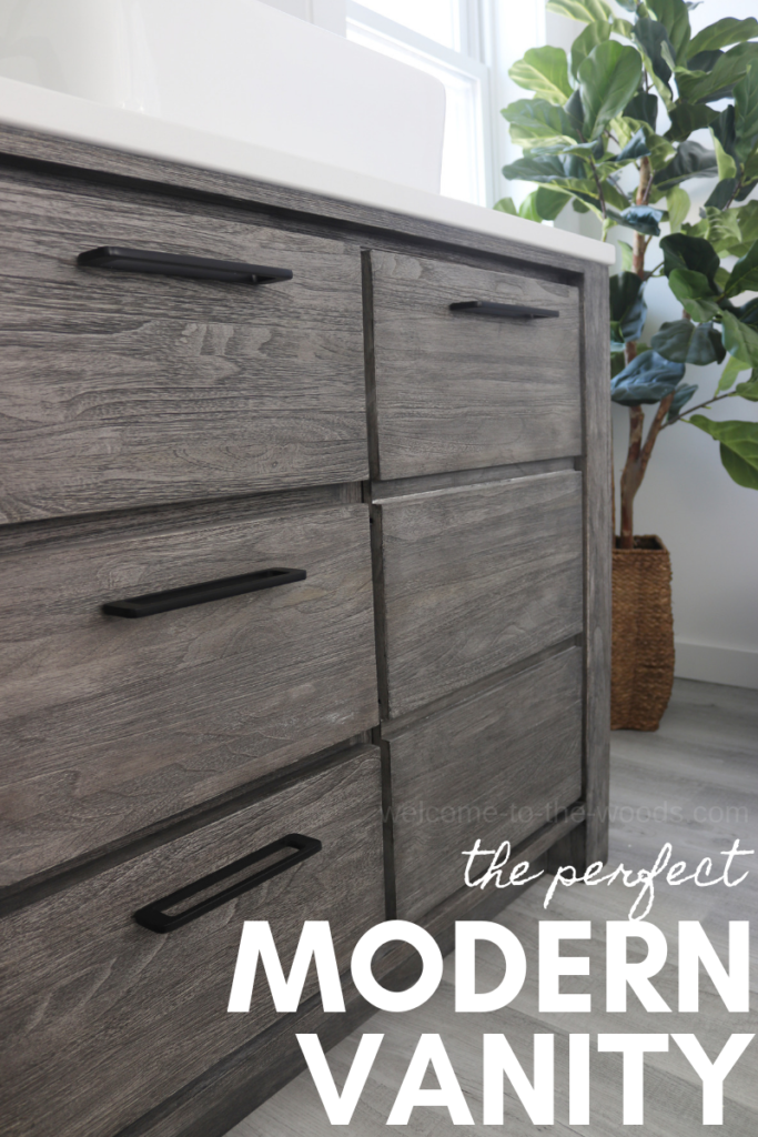 The perfect modern bathroom vanity with tons of storage, made of teak wood, gray wash neutral color with modern black hardware.