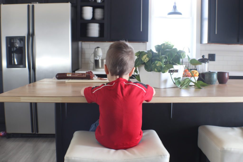 Little boy sitting at the kitchen island