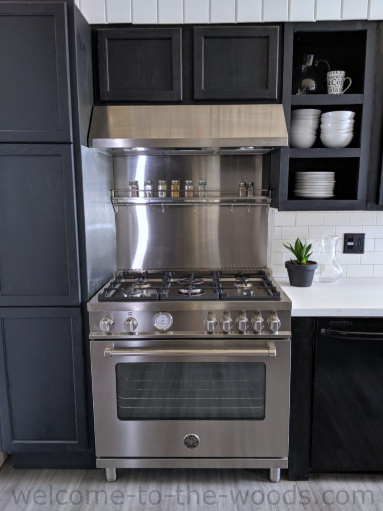 Elite Appliance Range in stainless steel with convection oven and 5 gas burners. Amazing modern style Black and white kitchen remodel