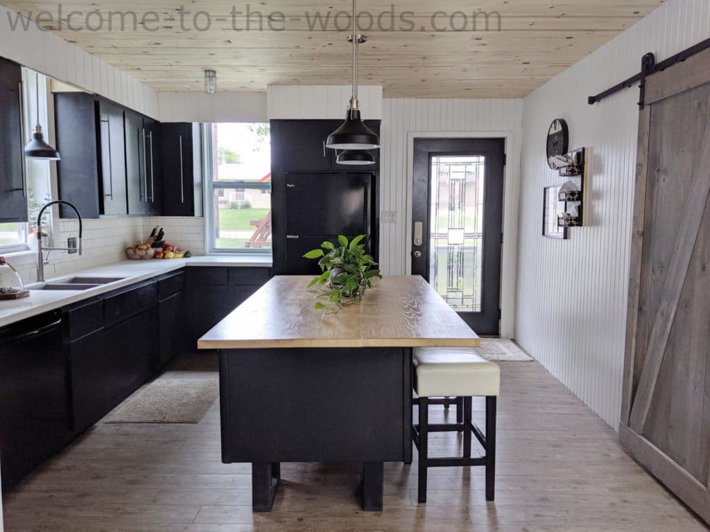 Modern black kitchen makeover diy island, lots of light, wood ceiling