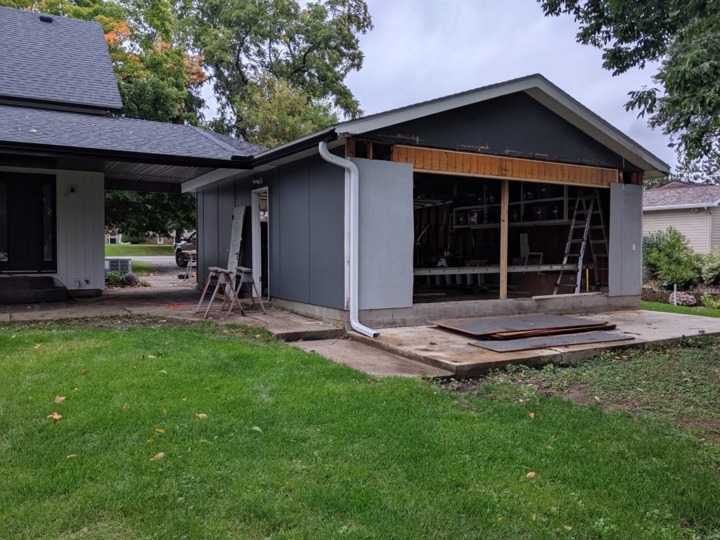 Installing new header on garage opening for a door exterior home renovation