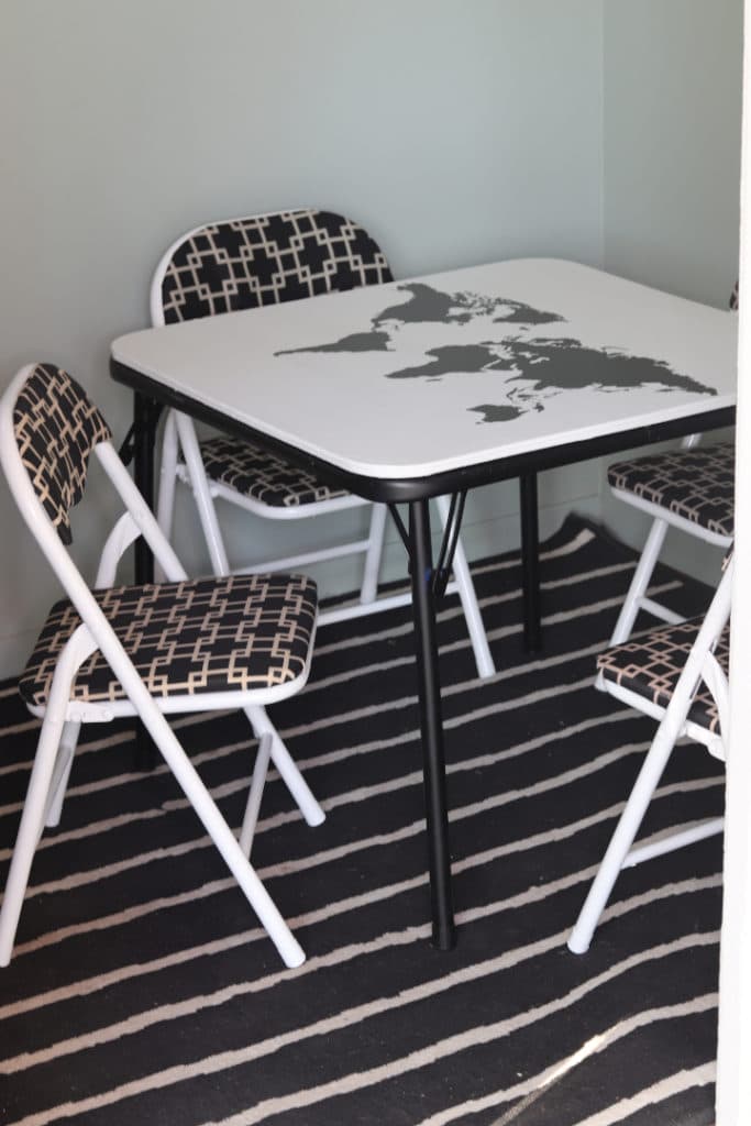 The kids' cluhouse off the front porch needed adorable furniture to match the black and white theme. I redid this kids table and chair furniture set with a map of the world hand painted on top! 