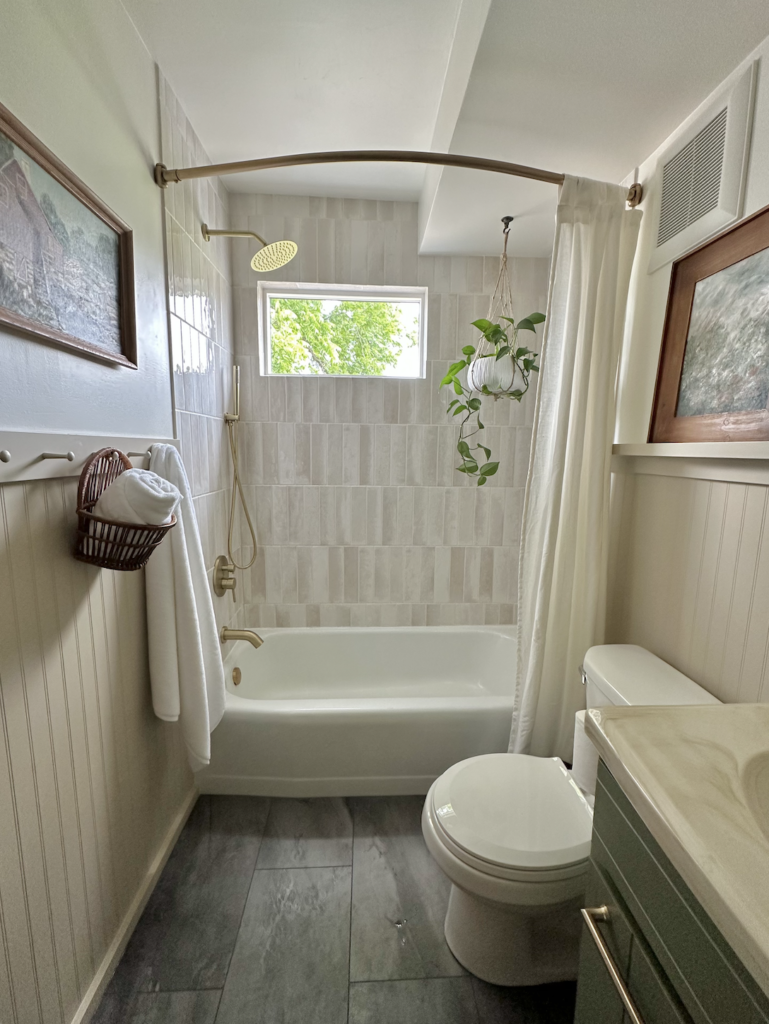 diy small bathroom style window in shower bathtub vanity toilet beadboard wall treatment lvp flooring tile surround