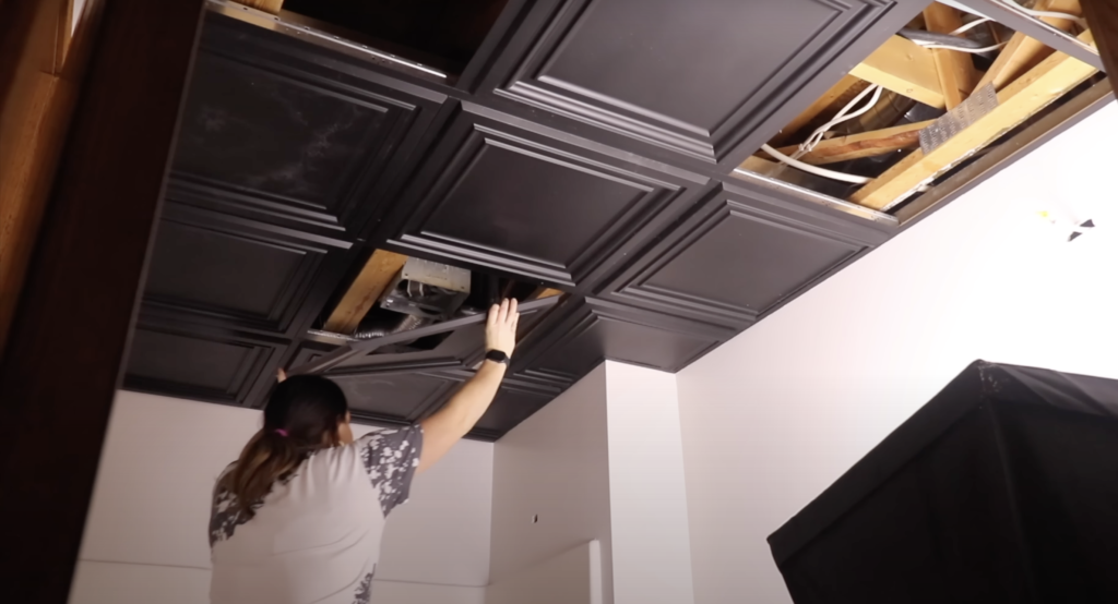 installing ceiling tiles 
